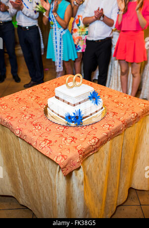 white floral wedding cake on restaurant interior background Stock Photo