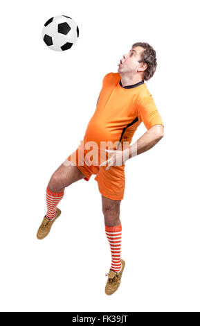 recreational fat football player kicking the ball isolated on a white background Stock Photo