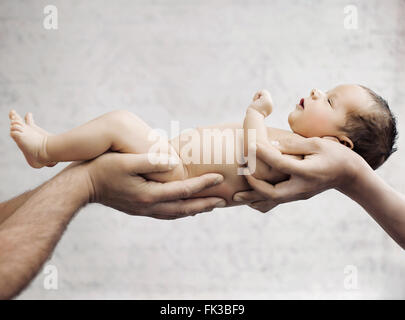 Newborn child sleeping on parents hand Stock Photo