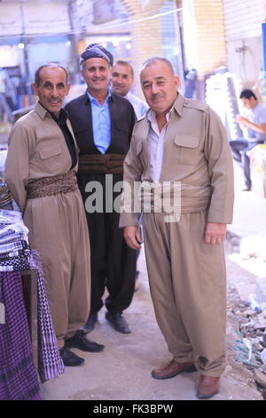 Kurdish man in traditional dress sitting at his shop in Erbil, Northern ...