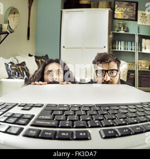 Two funny IT specialists staring at a keyboard Stock Photo