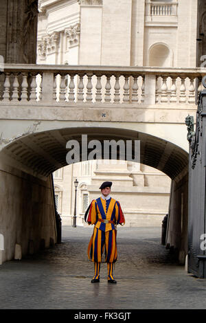 A Swiss Guard soldier stands at attention guarding St. Peter's Basilica in The Vatican. Stock Photo