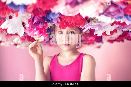 Cute little cutie among colorful flowers Stock Photo