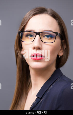 Young attractive businesswoman with long hair in eyeglasses Stock Photo