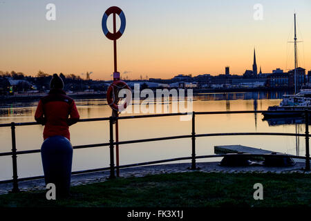 Preston, UK. 7th March 2016. UK Weather. There was a bright, sunny start to the day as the sun came up across Presyon docks, with St Walburge's church in the background. Credit:  Paul Melling/Alamy Live News Stock Photo