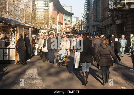 Shoppers in St. Annes Square Manchester enjoying the winter sunshine. Stock Photo