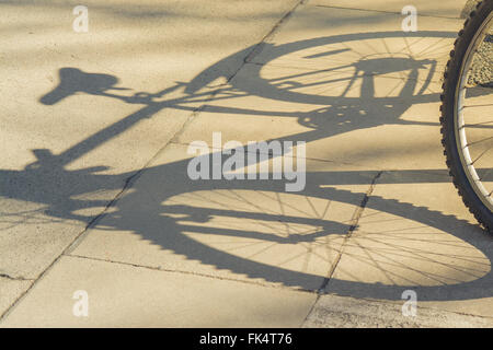 shadow of bike on pavement Stock Photo