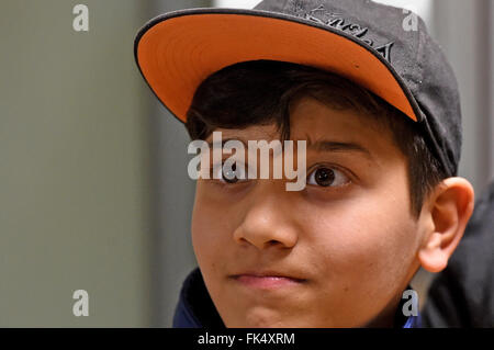 Hanover, Germany. 07th Mar, 2016. Afghan refugee boy Mahdi Rabani enters the arrivals hall of the Hanover-Langenhagen Airport in Hanover, Germany, 07 March 2016. Mahdi went missing at the start of 2015 during passage to Greece. An aid-worker with the German Red Cross did not give up and eventually tracked down the 10-year-old boy in Switzerland, where he had landed with another Afghan family. Photo: HOLGER HOLLEMANN/dpa/Alamy Live News Stock Photo