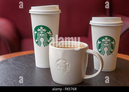 Starbucks coffee cups on a table Stock Photo