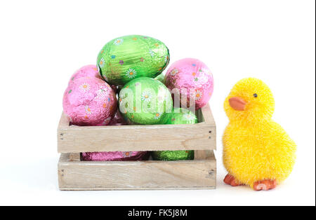A little chicken and a box with easter eggs Stock Photo