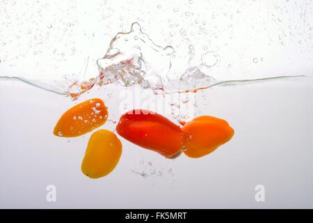 Small Peppers smashed into Water Stock Photo