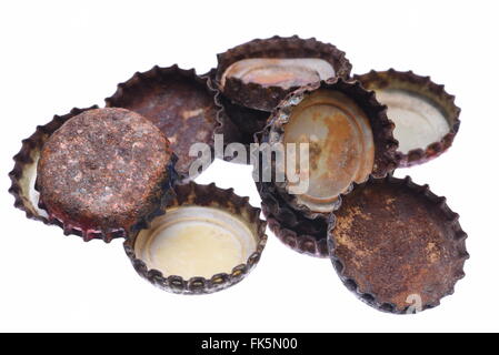 Group of old rusty bottle caps isolated on white background Stock Photo