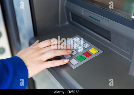 close up of hand entering pin code at cash machine Stock Photo
