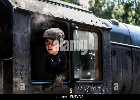 Young person looking out from drivers cab on  steam train Norfolk England Stock Photo