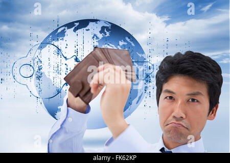 Composite image of businessman showing his empty wallet Stock Photo