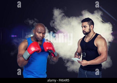 Composite image of strong friends using kettlebells together Stock Photo