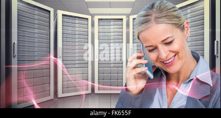 Composite image of smiling businesswoman using mobile phone Stock Photo