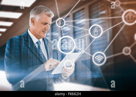 Composite image of businessman using his tablet Stock Photo