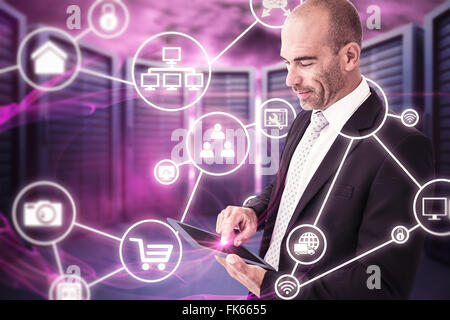 Composite image of businessman using a tablet Stock Photo