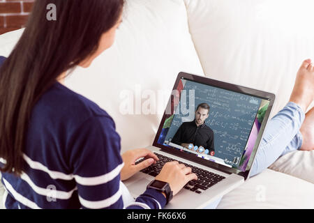Composite image of portrait of creative business people with technologies at desk Stock Photo