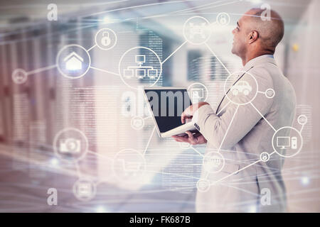 Composite image of businessman using laptop Stock Photo