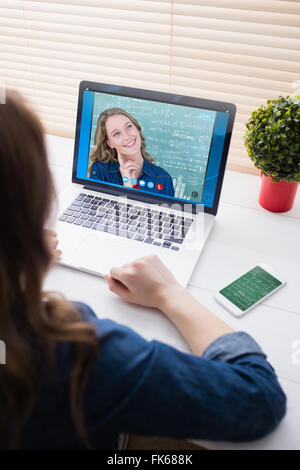 Composite image of thoughtful teacher smiling in front of blackboard Stock Photo