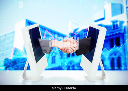 Composite image of close up of two businesspeople shaking their hands Stock Photo