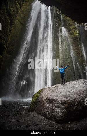 Tourist at the hidden Gljufrabui Waterfall, near Seljalandsfoss, South Iceland (Sudurland), Iceland, Polar Regions Stock Photo