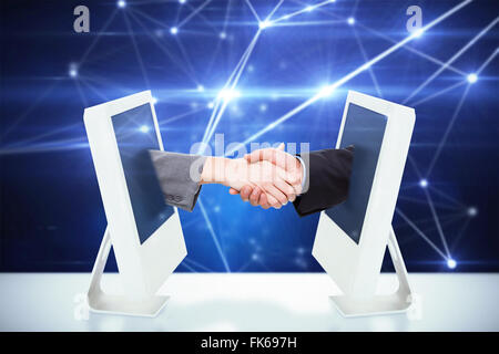 Composite image of close up of two businesspeople shaking their hands Stock Photo