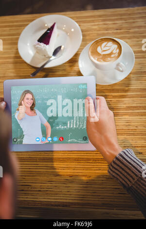 Composite image of smiling teacher gesturing thumbs up in front of blackboard Stock Photo