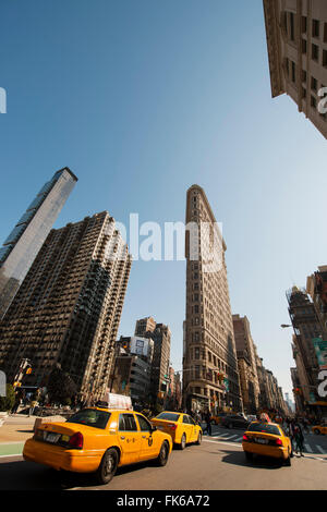 Flat Iron Building and yellow cabs at the intersection of 5th Avenue and Broadway, New York, United States of America Stock Photo