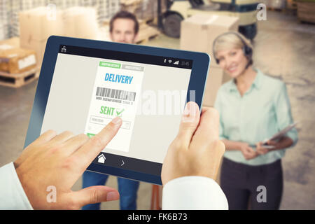 Composite image of man using tablet pc Stock Photo