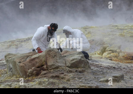 Geologists taking mineral samples on Gran Cratere, Vulcano Island, Aeolian Islands, UNESCO, Sicily, Italy Stock Photo