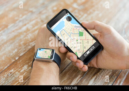 close up of hands with smart phone and watch Stock Photo