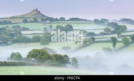 Rolling mist covered countryside surrounding Brentor Church, Dartmoor, Devon, England, United Kingdom, Europe