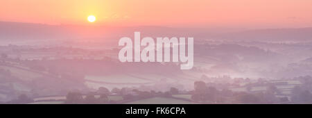 Sunrise over mist covered rolling countryside, Dartmoor, Devon, England, United Kingdom, Europe Stock Photo