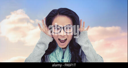 Composite image of asian woman shouting to the camera Stock Photo