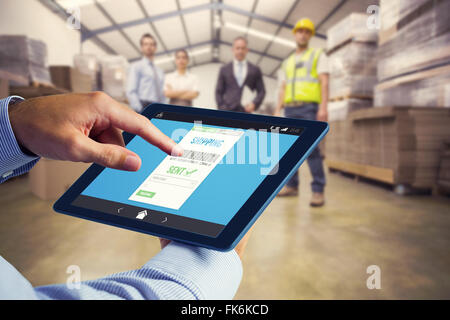 Composite image of man using tablet pc Stock Photo