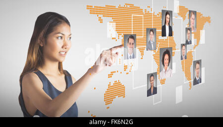 Composite image of smiling businesswoman pointing Stock Photo