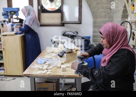 (160307) -- GAZA, March 7, 2016 (Xinhua) -- Palestinian women work inside a carpentry workshop in Gaza City, on March 7, 2016. 13 women work in the carpentry workshop, producing woodcarvings, especially those for children. (Xinhua/Wissam Nassar) Stock Photo