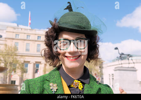 Beautiful young woman in a gorgeous green hat at Tweed Run (bicycle ride with a style) Stock Photo