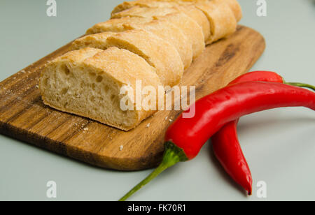 Slices of baguette with two chilies Stock Photo