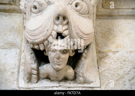 Monster or Tarasque Devouring a Sinner c12th Romanesque Carving in the Cloisters Montmajour Abbey near Arles Provence France Stock Photo