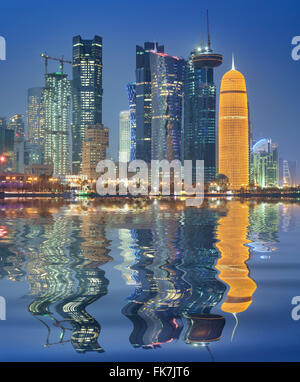 Night view of skyline along waterfront of Corniche towards modern office towers in Doha Qatar Stock Photo