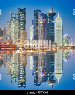 Night view of skyline along waterfront of Corniche towards modern office towers in Doha Qatar Stock Photo