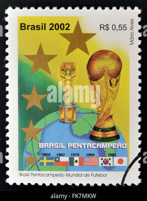 BRAZIL - CIRCA 2002: a stamp printed in Brazil showing an image of the World Cup trophy and the years that Brazil won the World Stock Photo