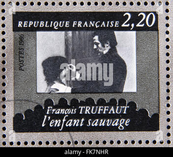 FRANCE - CIRCA 1986: stamp dedicated to centenary of the French cinema shows Francois Truffaut 'The Wild Child', circa 1986 Stock Photo