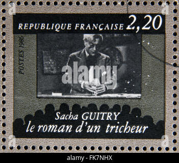 FRANCE - CIRCA 1986: stamp dedicated to centenary of the French cinema shows Sacha Guitry 'The romance of a cheater', circa 1986 Stock Photo