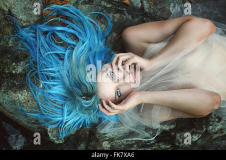 Beautiful river nymph posing on rocks . Fantasy and myth Stock Photo