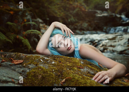 Beautiful young woman day dreaming in the wood. Fantasy and myth Stock Photo
